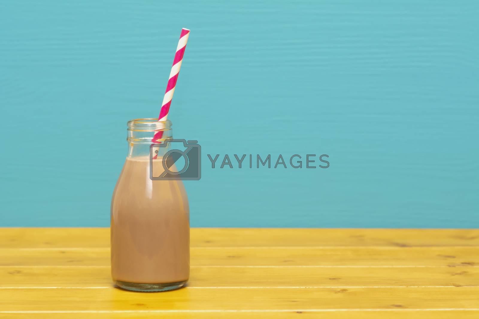 Royalty free image of Chocolate milkshake with a retro straw in a glass bottle by sarahdoow