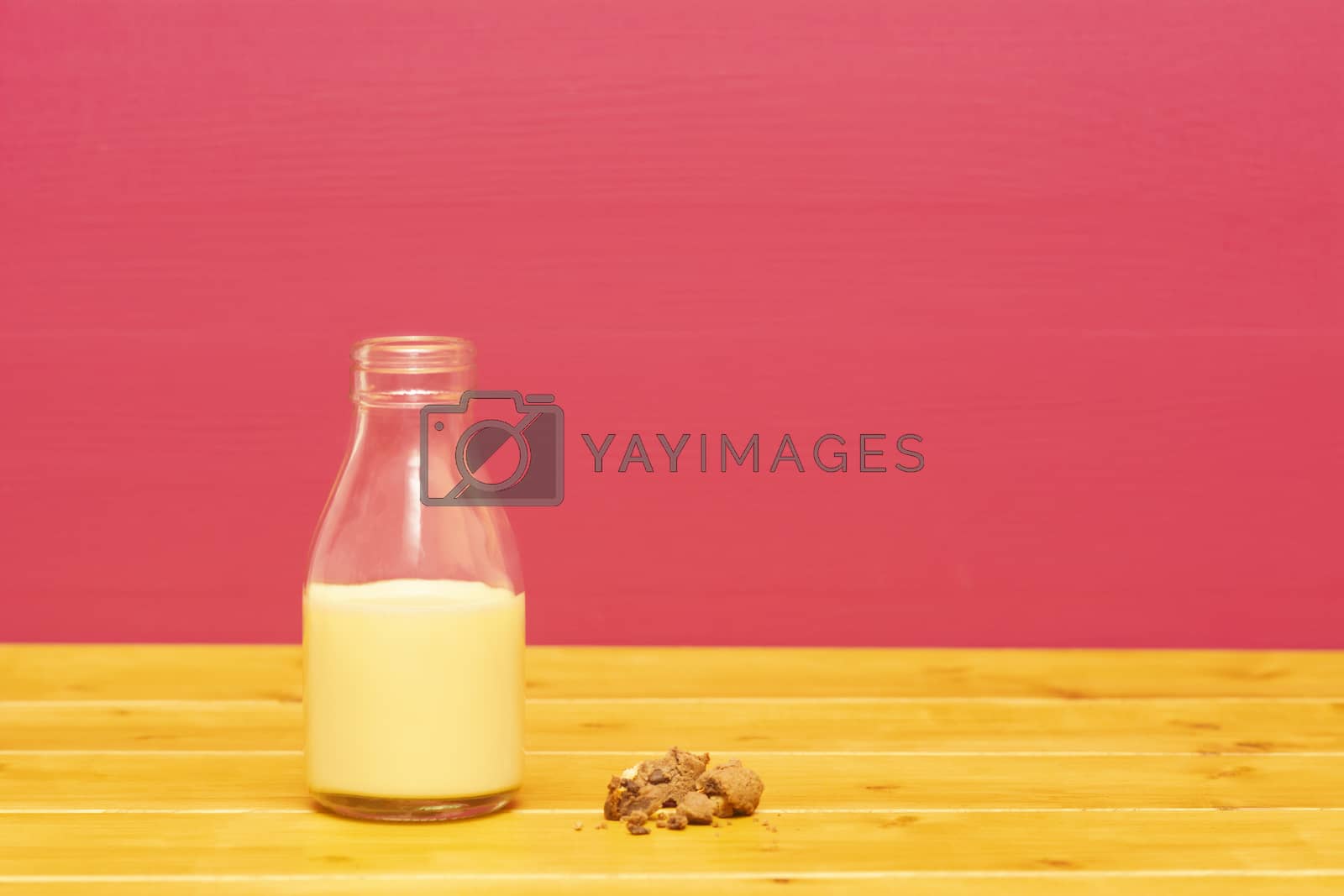 Royalty free image of Half bottle of banana milkshake and a half-eaten cookie by sarahdoow