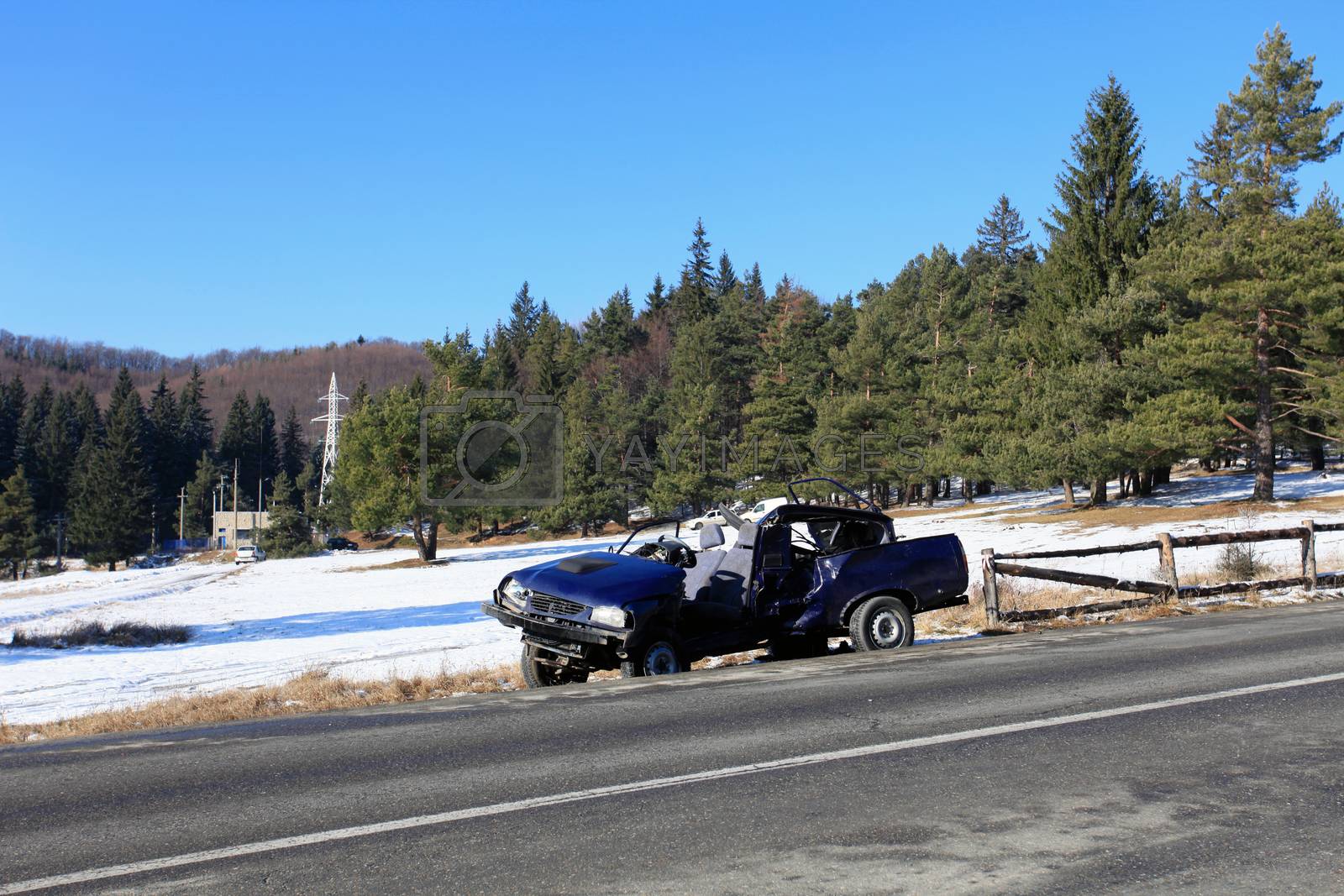 Royalty free image of Front of blue car damaged by crash accident on side of the road by PixAchi