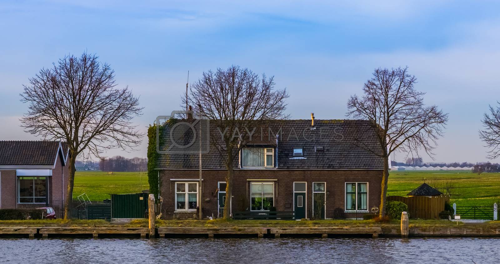 Royalty free image of Terraced house with water at the country side, city scenery of Alphen aan den rijn, The Netherlands by charlottebleijenberg