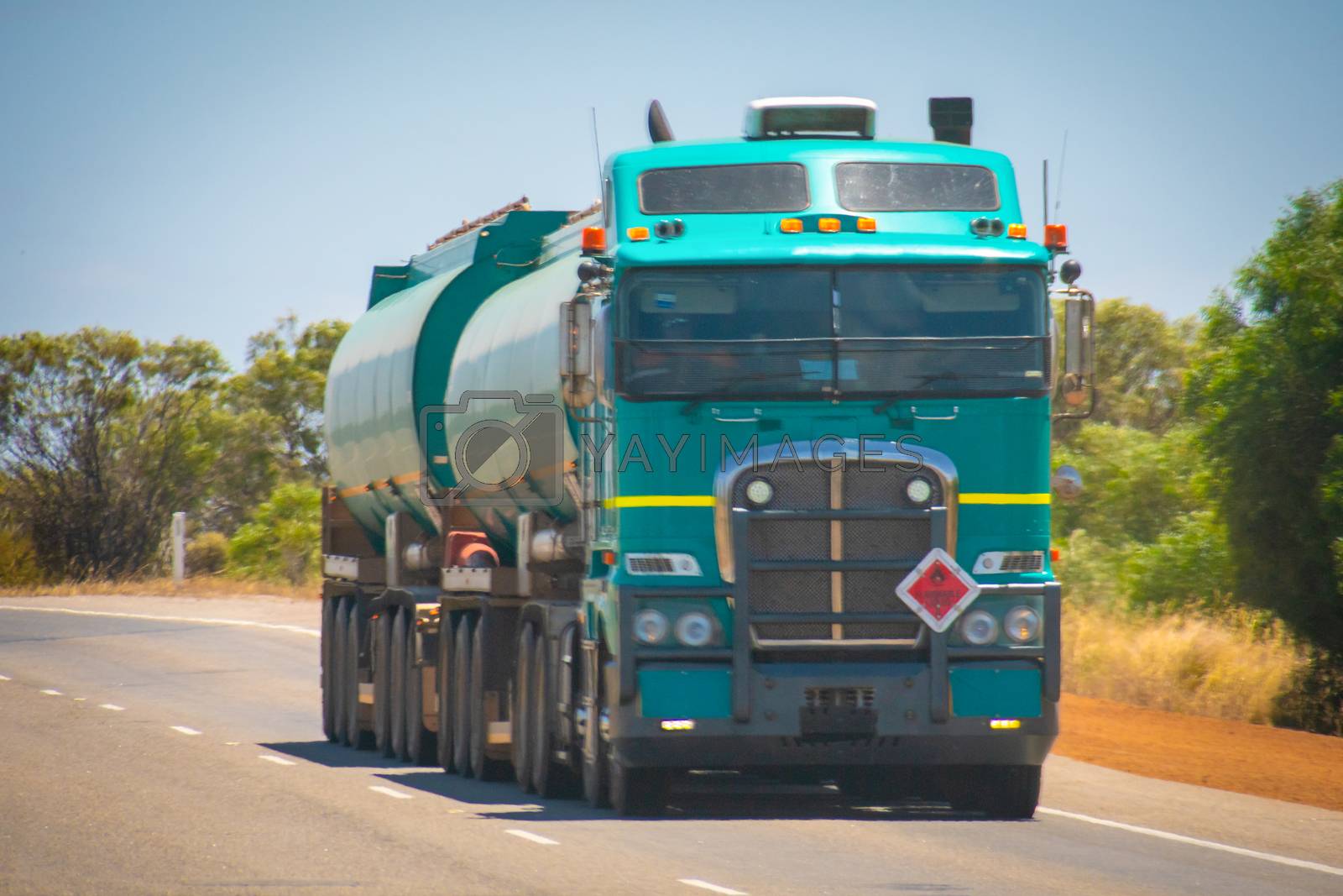 Royalty free image of Long Road Train in the Australian Outback with trailer bringing fuel to gas station by MXW_Stock