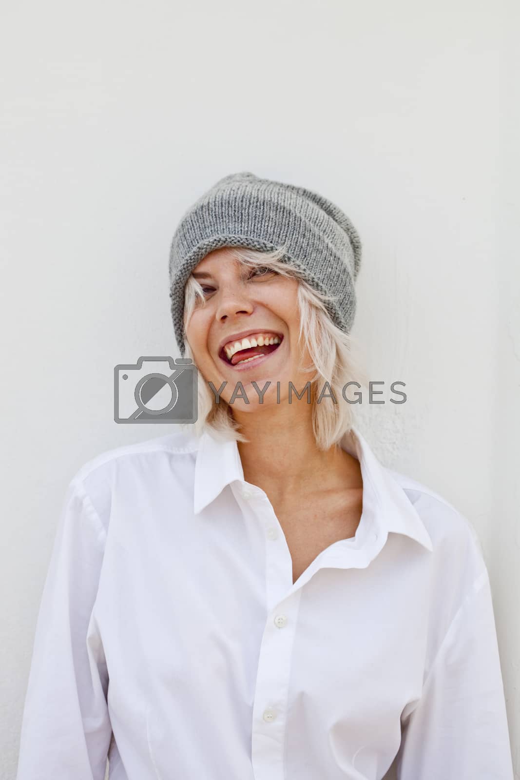 Royalty free image of Beautiful happy young woman in warm grey beanie. by marylooo