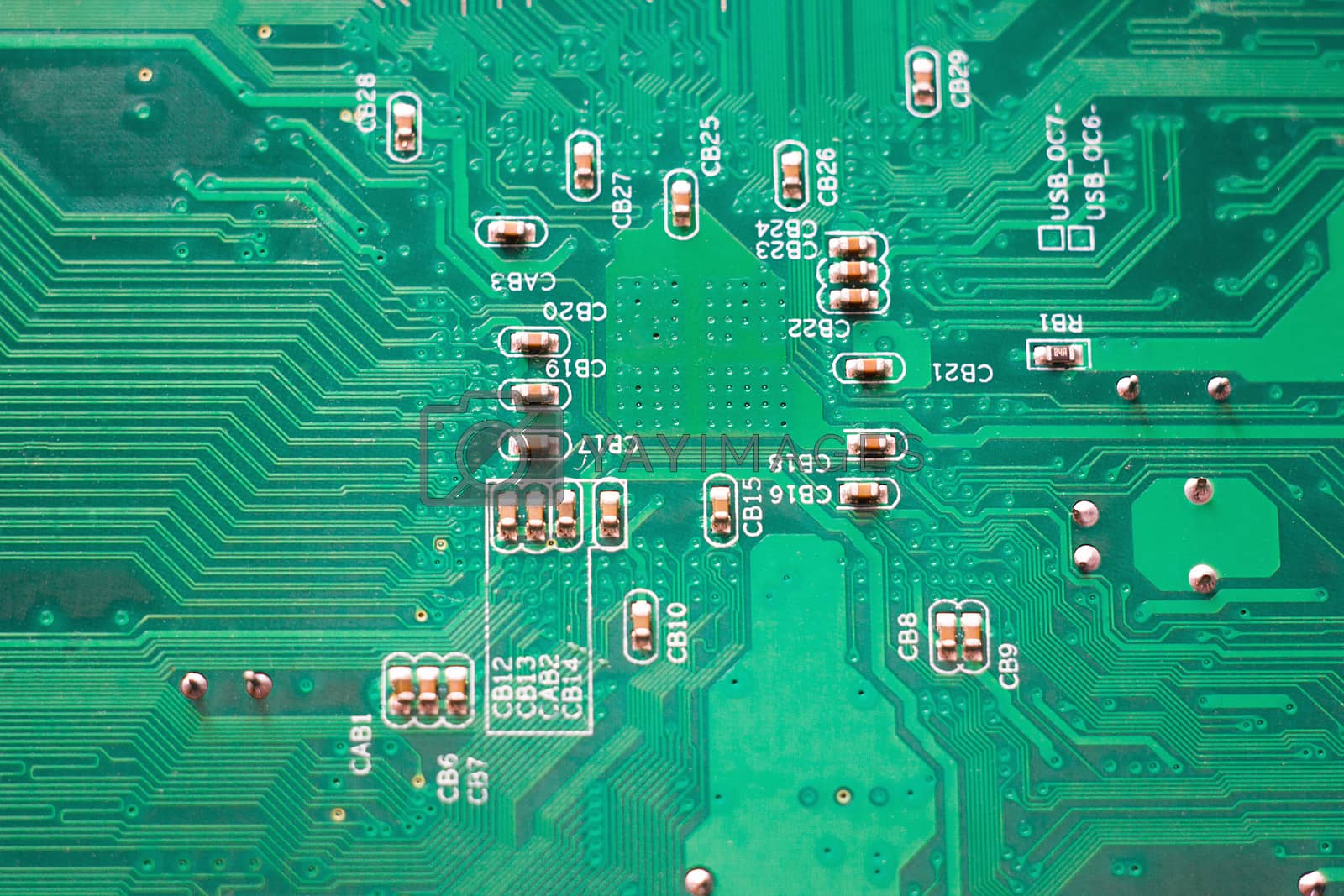 Royalty free image of close-up microcircuit, green pc motherboard by kasynets_olena