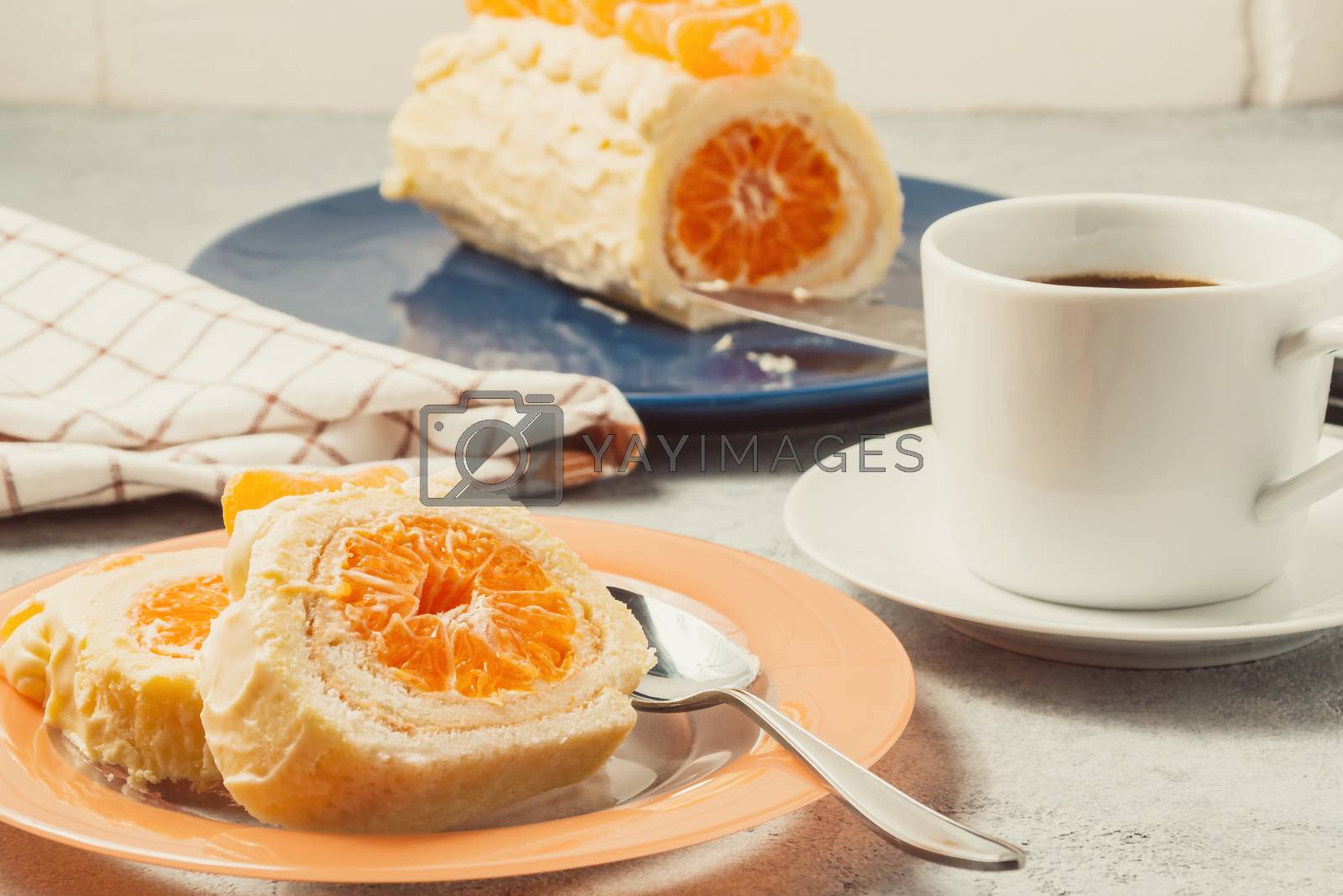 Royalty free image of Sweet roll with whipped cream and tangerine filling and a cup of coffee by galsand