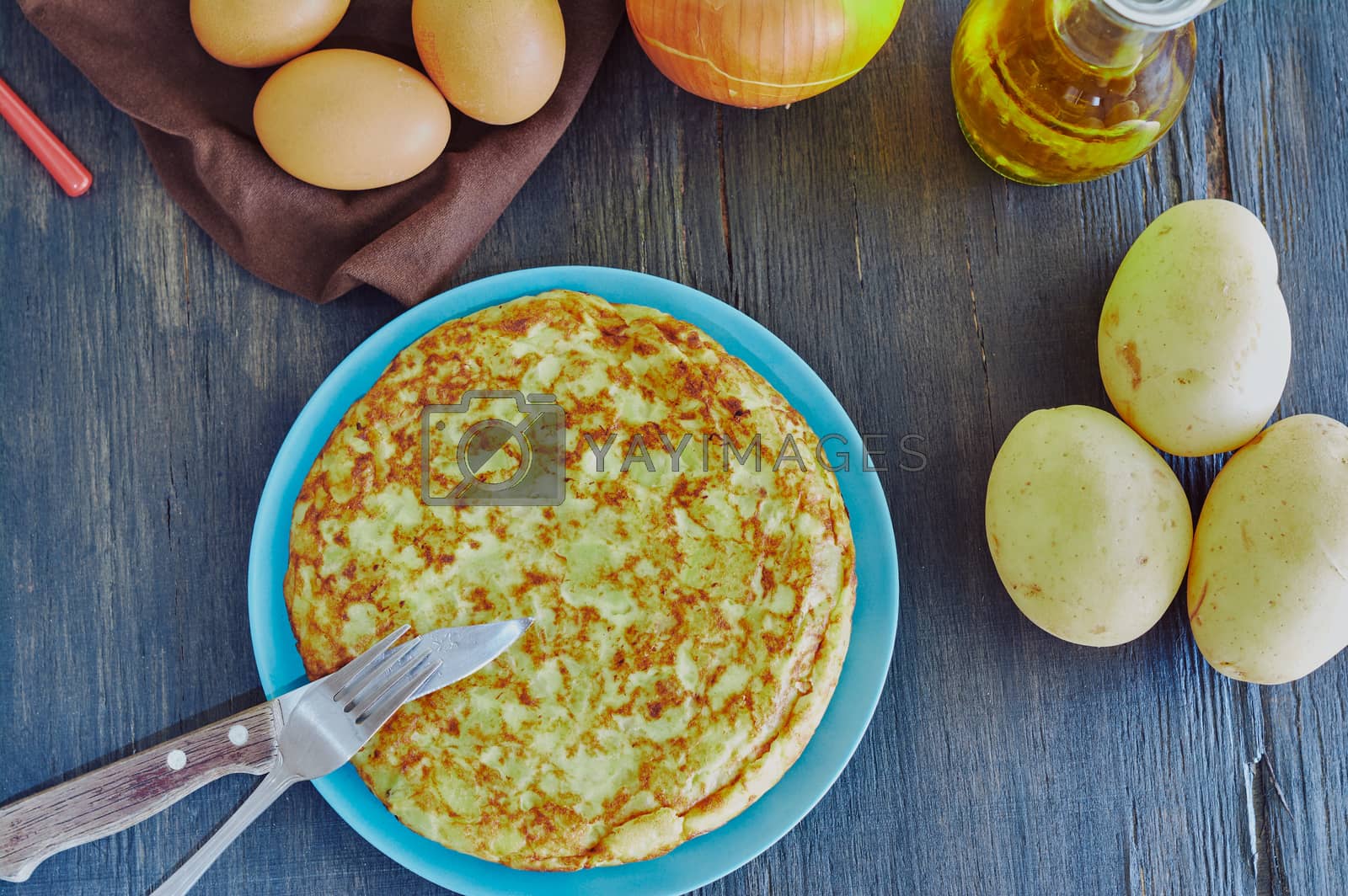 Royalty free image of Spanish omelette with potato, egg and onion, accompanied by olive oil by Prf_photo