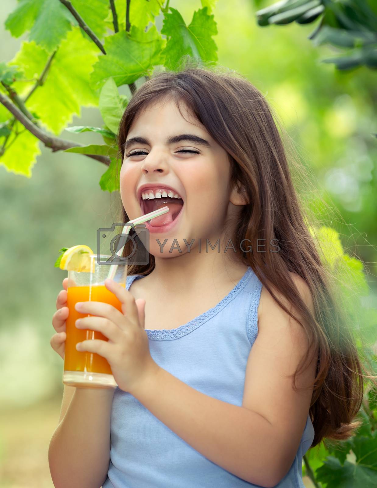 Royalty free image of Joyful girl drinking juice by Anna_Omelchenko