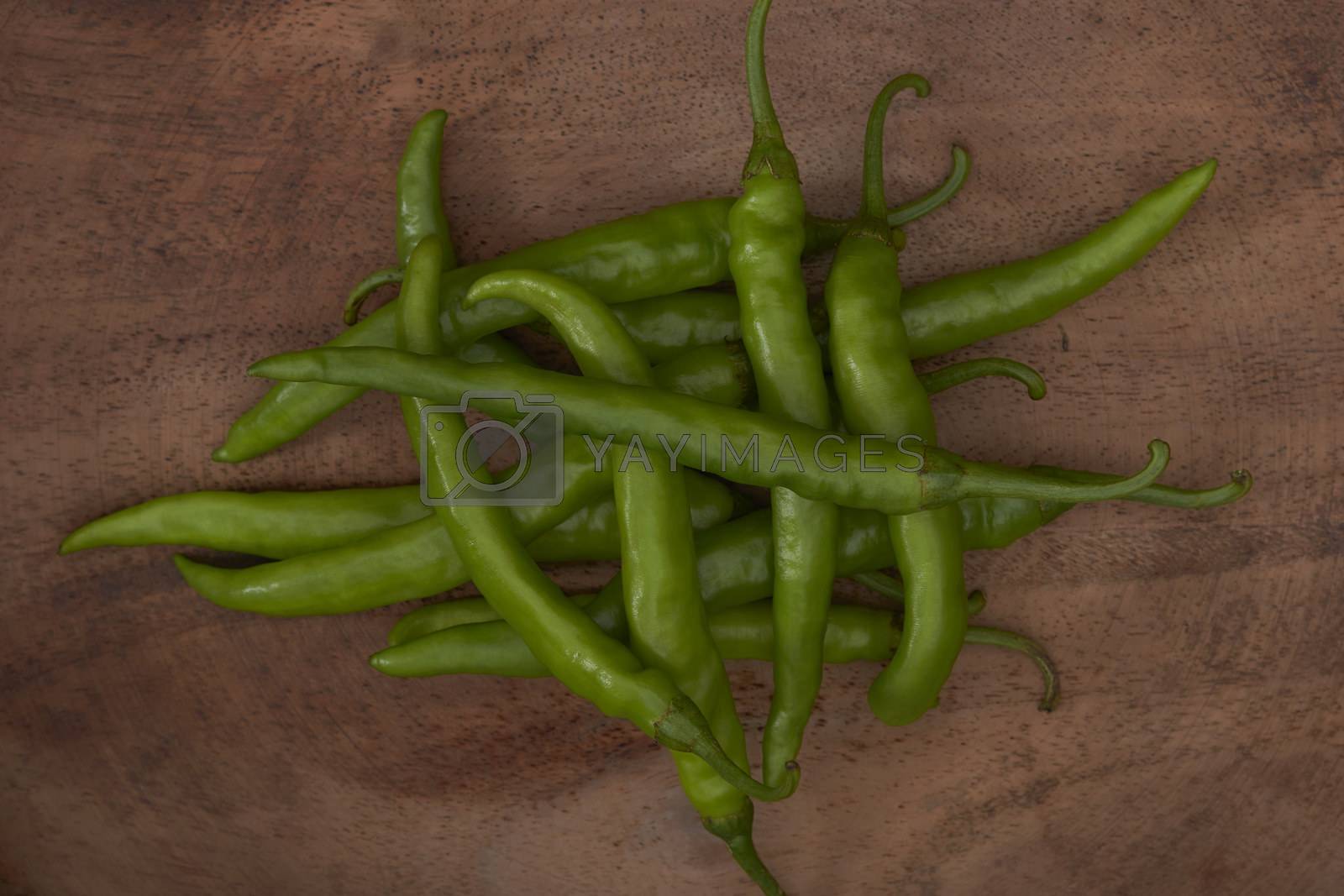 Royalty free image of Fresh green chillies on a wooden tray by vinodpillai