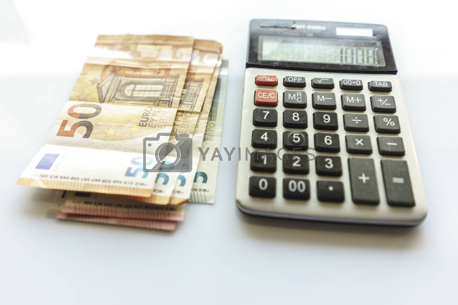 Royalty free image of Banknotes and Calculator, Euro Banknotes on White Background by Supertooper