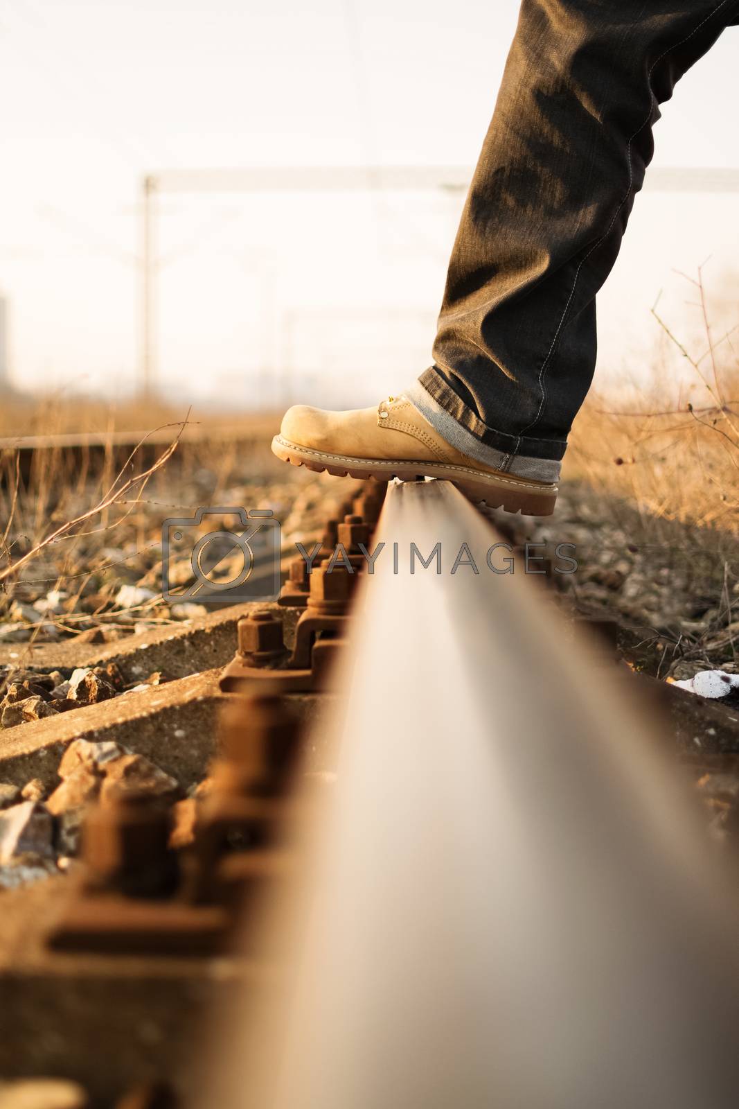 Royalty free image of Stepping over the train tracks by Mendelex