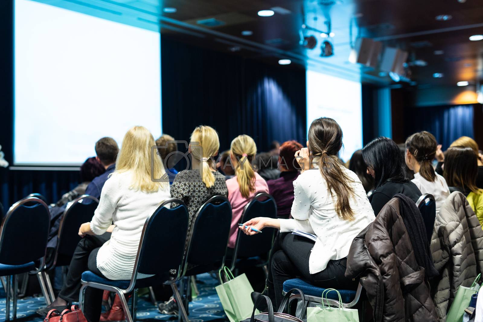 Royalty free image of Audience in the lecture hall attending scientific business conference. by kasto