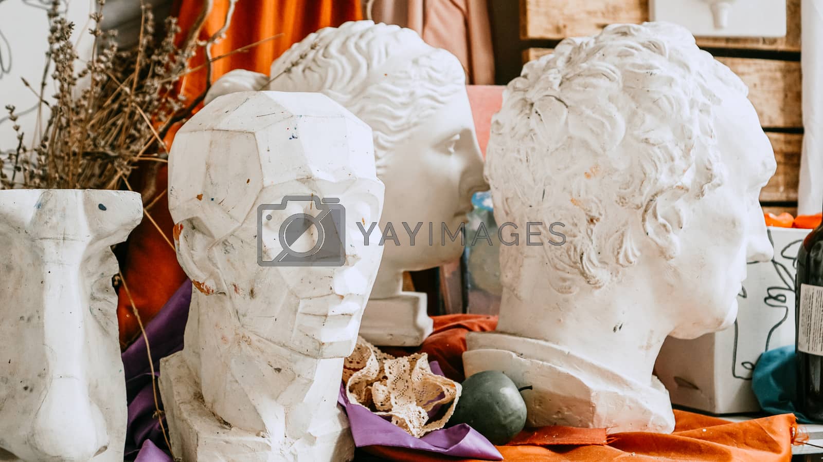 Royalty free image of Sculpture bust and tools in an art workshop by natali_brill