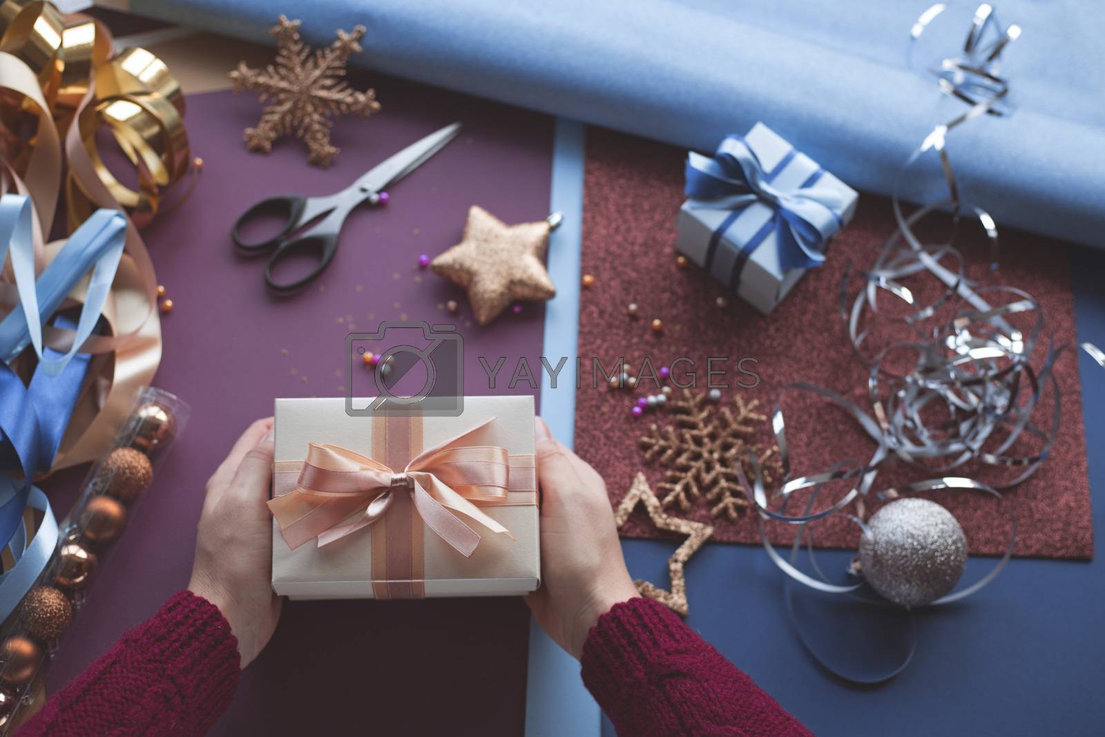 Royalty free image of Hands holding present for Christmas by destillat