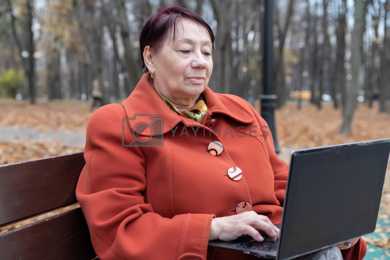Royalty free image of Senior woman in the park in autumn by bonilook
