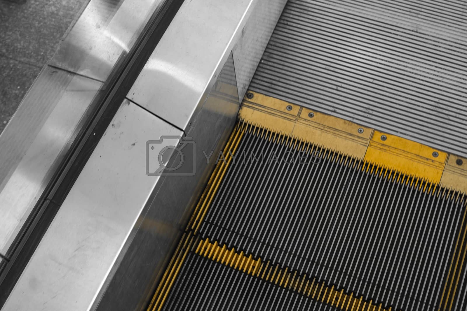 Royalty free image of Ditry stairs on Escalator with yellow strips. by vovsht