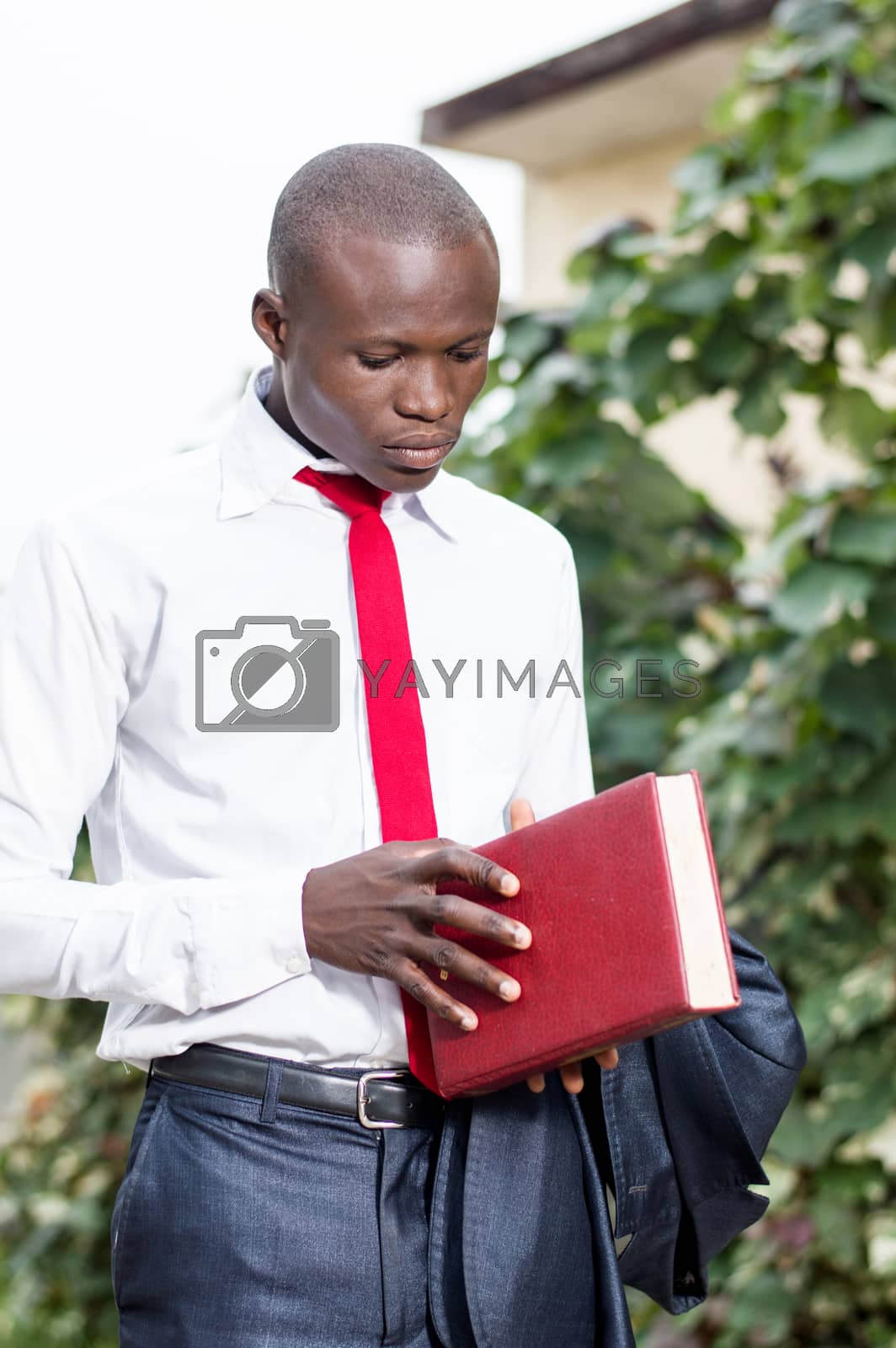 Royalty free image of Young student holding a book. by vystek