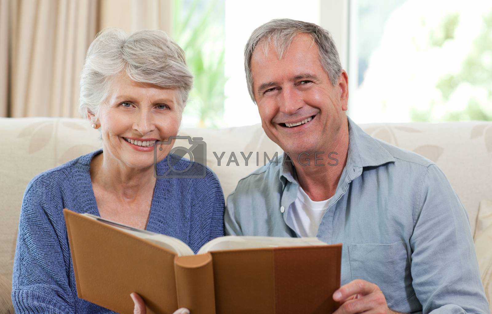 Royalty free image of Seniors looking at their photo album by Wavebreakmedia