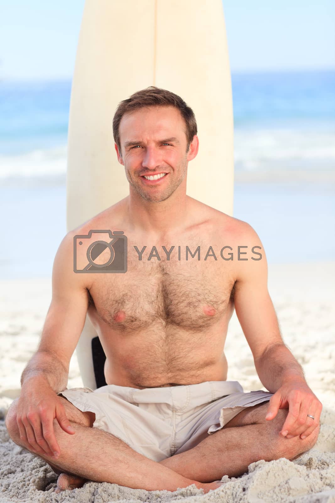 Royalty free image of Man with his surfboard by Wavebreakmedia