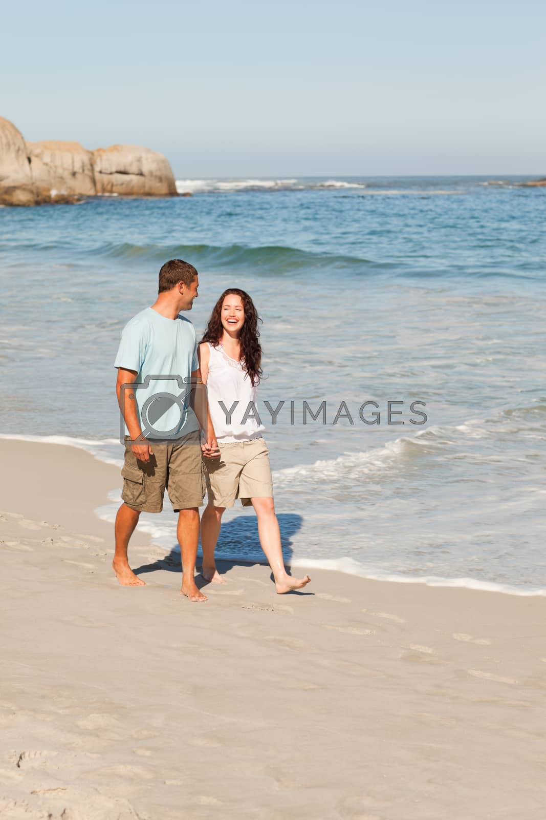 Royalty free image of Couple walking on the beach by Wavebreakmedia