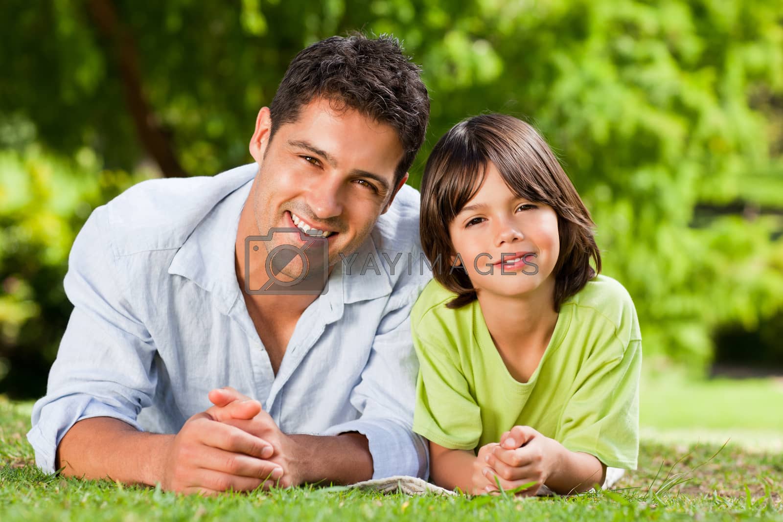 Royalty free image of Father and his son lying down by Wavebreakmedia