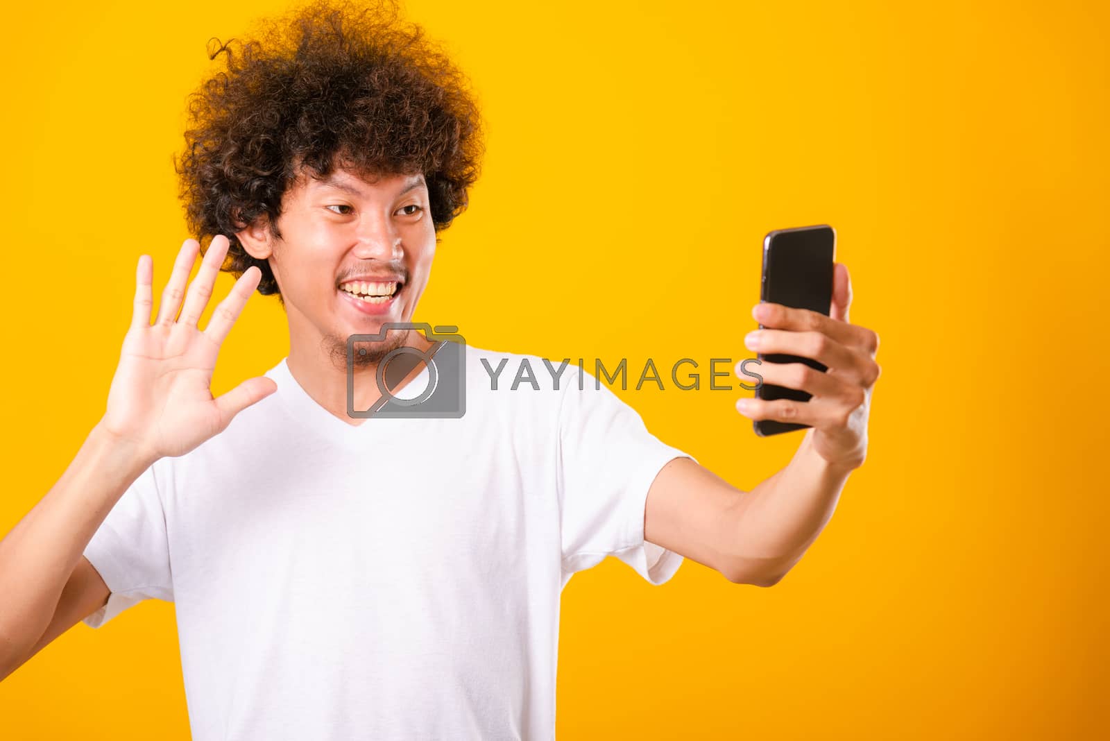 Royalty free image of Portrait asian handsome man curly hair taking selfie with mobile by Sorapop