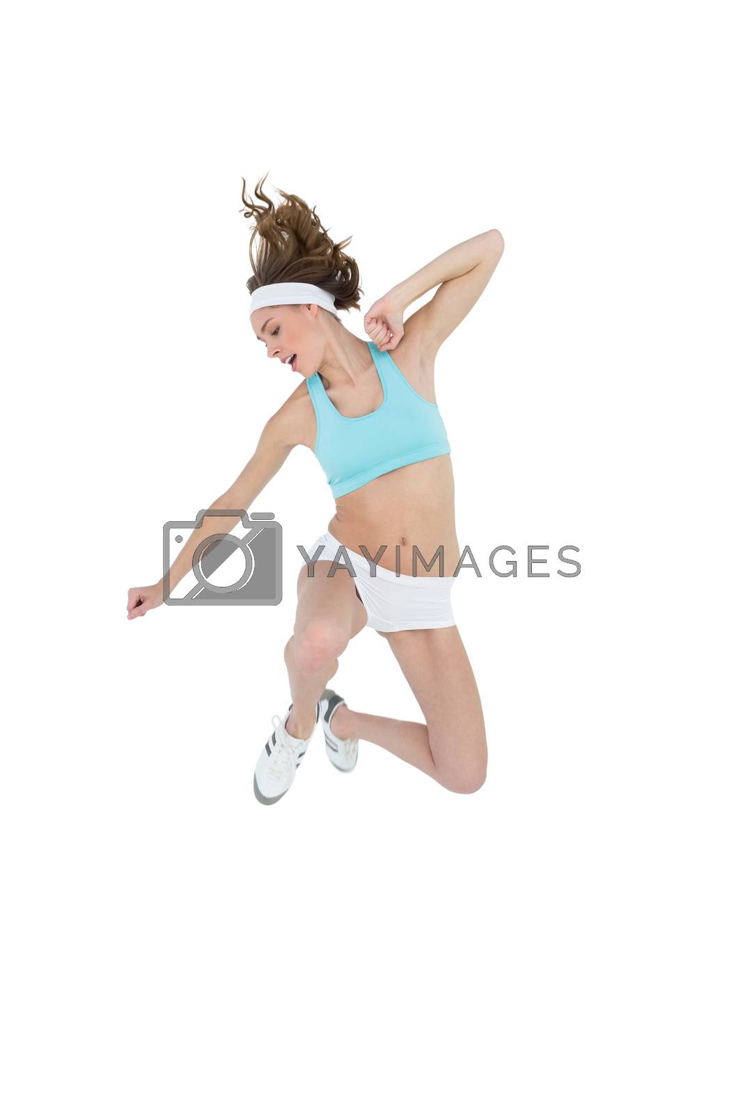 Royalty free image of Sporty slender woman wearing sportswear jumping by Wavebreakmedia