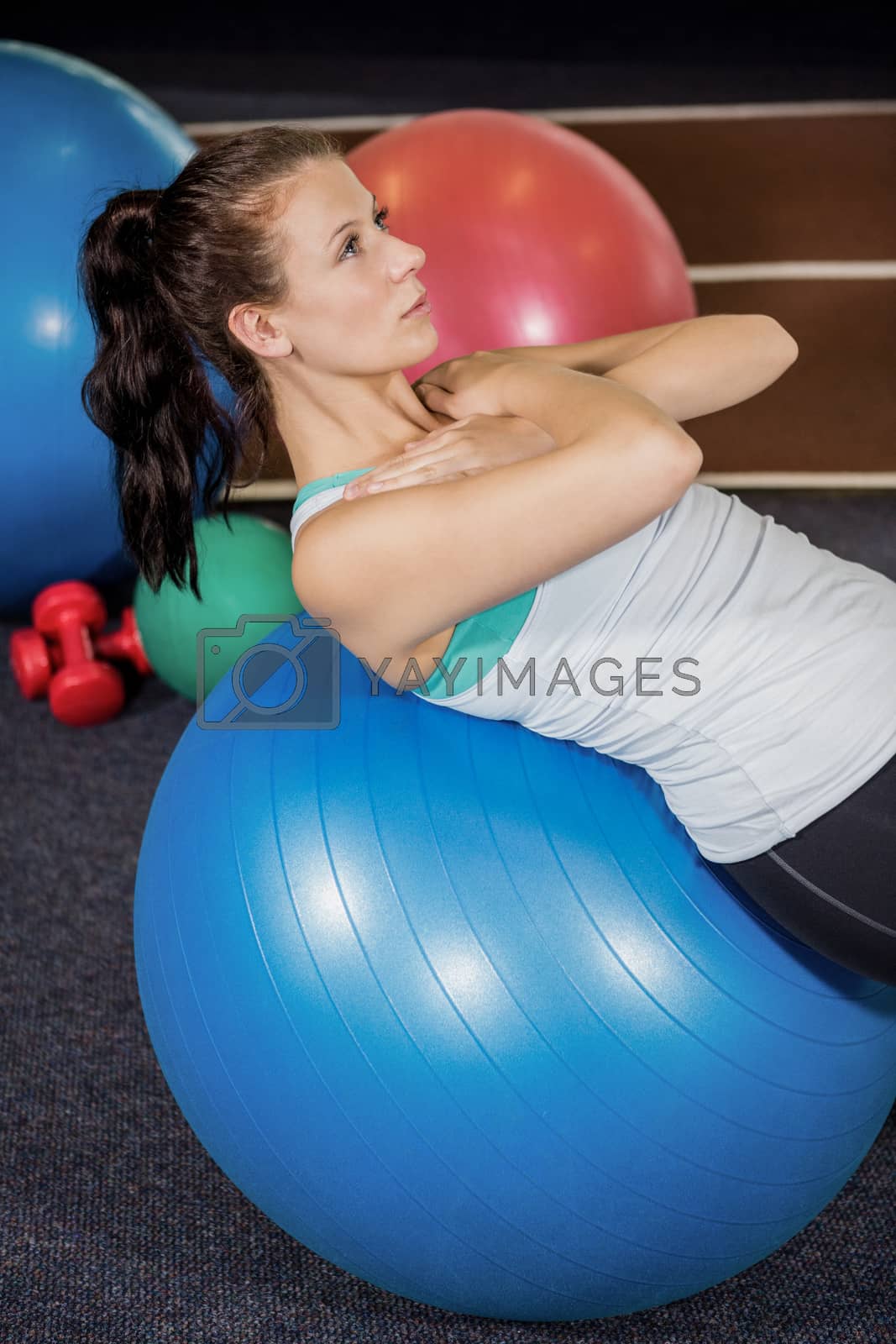 Royalty free image of Woman working out on fitness ball by Wavebreakmedia