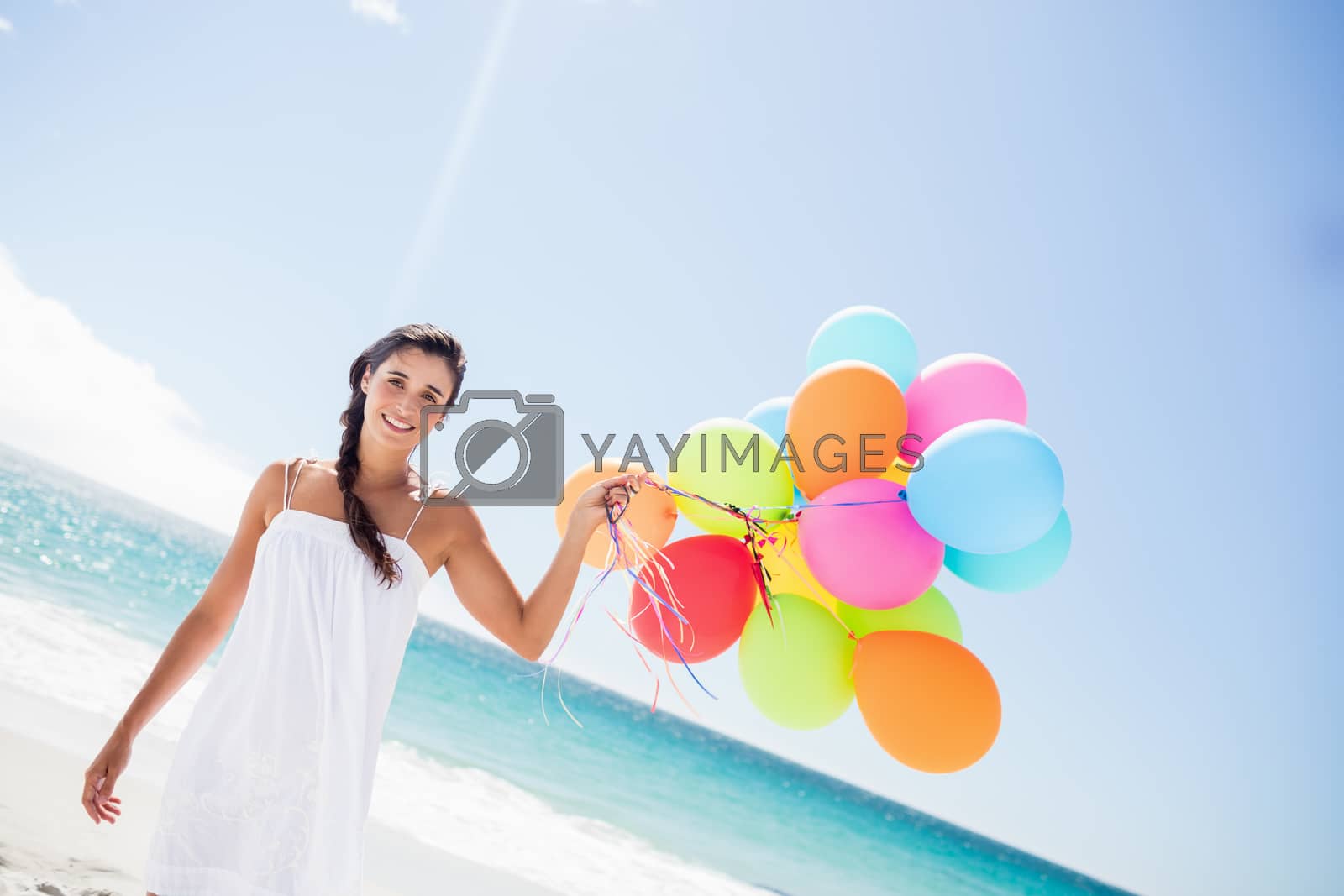 Royalty free image of  Beautiful woman holding balloon by Wavebreakmedia