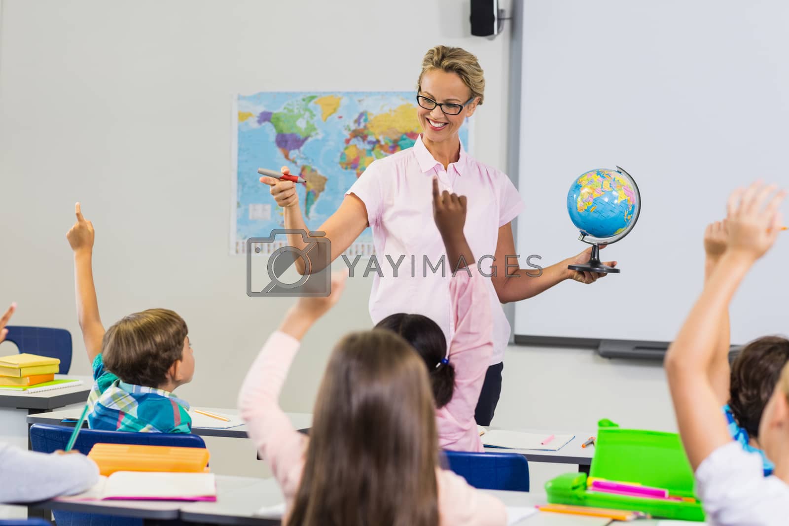 Royalty free image of Teacher having lesson with a globe by Wavebreakmedia