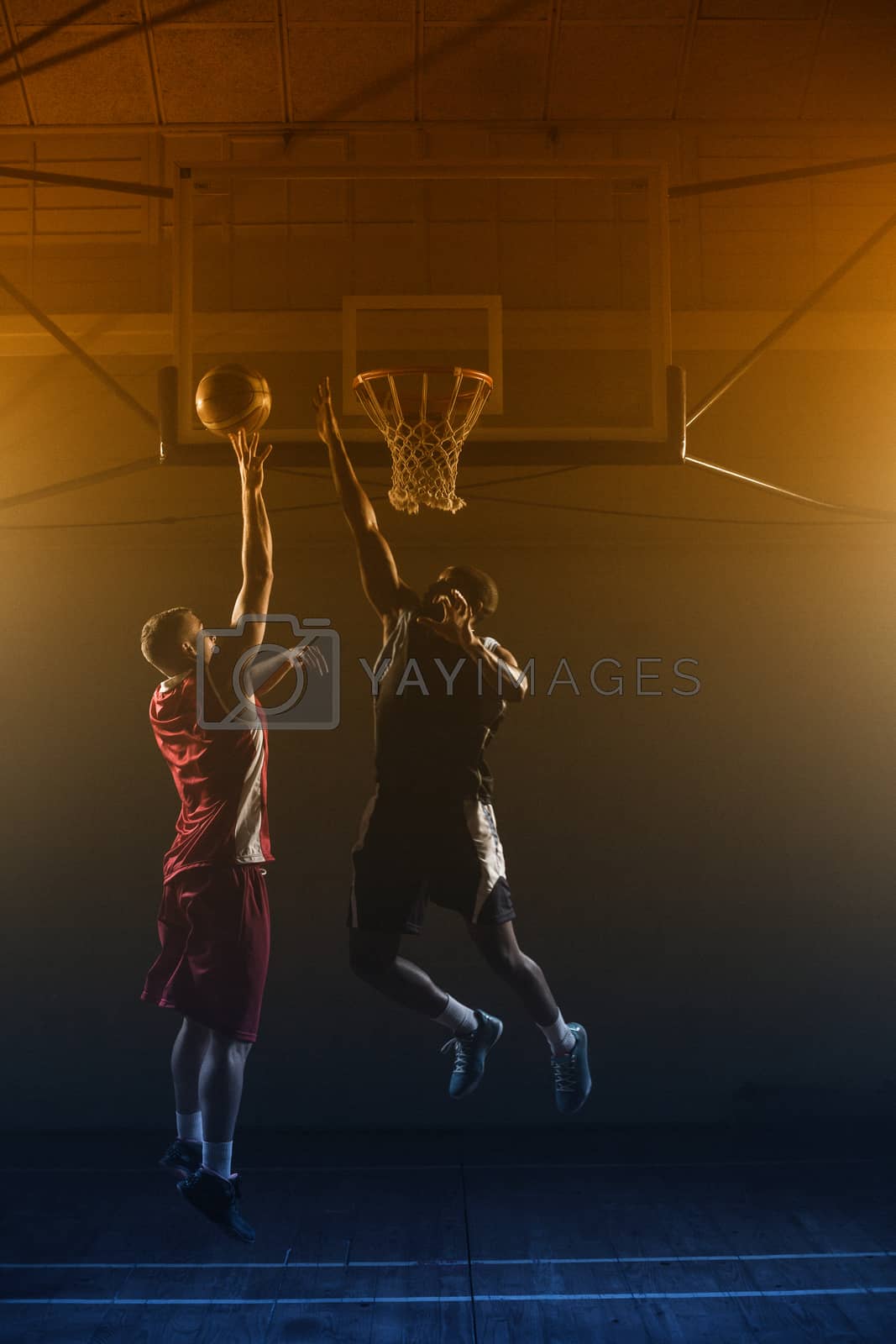 Royalty free image of Basketballs player trying to scoring a basket by Wavebreakmedia