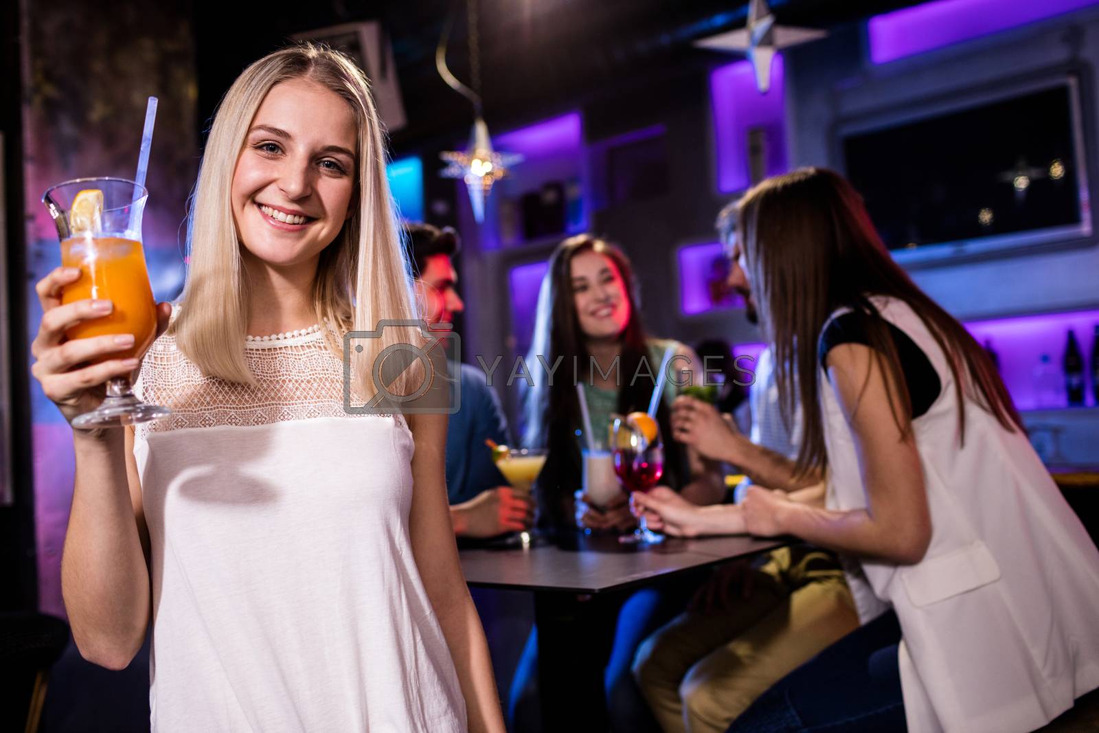 Royalty free image of Portrait of beautiful woman having a cocktail  by Wavebreakmedia