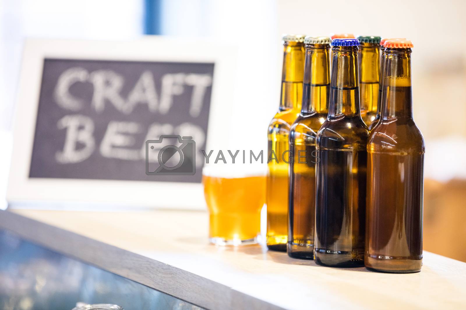 Royalty free image of Beer glasses and bottles on the bar counter by Wavebreakmedia