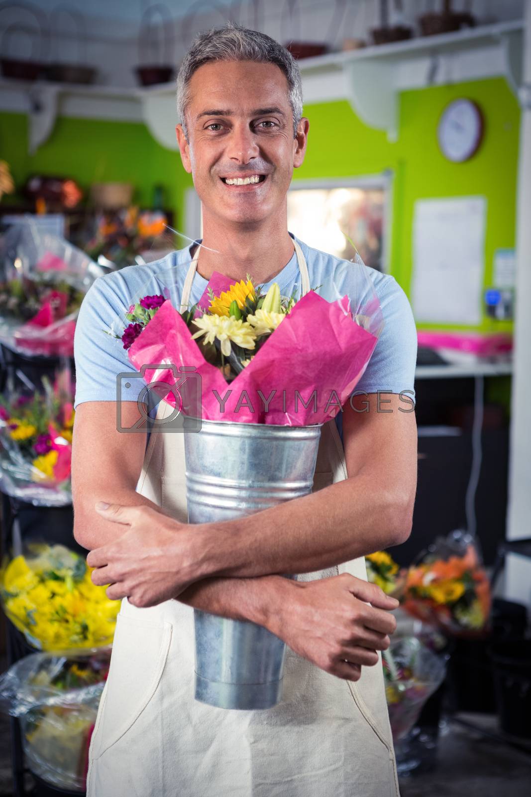 Royalty free image of Male florist holding flower bouquet at flower shop by Wavebreakmedia