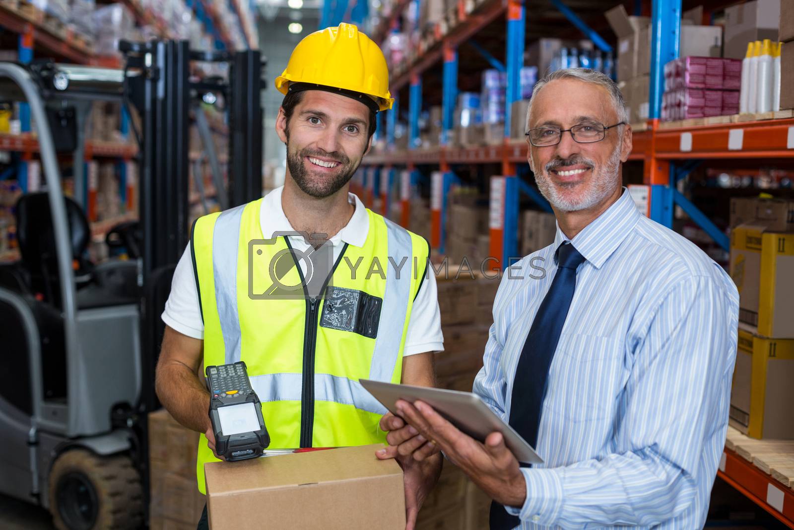 Royalty free image of Businessman and warehouse worker by Wavebreakmedia