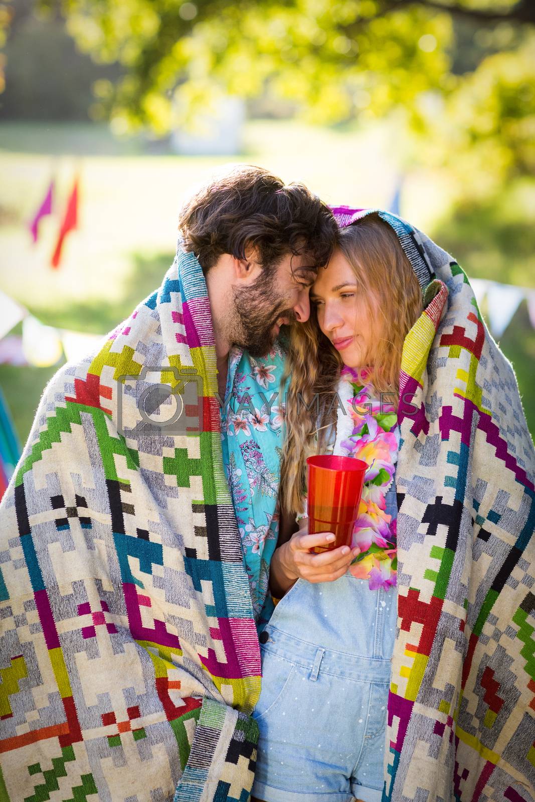 Royalty free image of Couple wrap themselves in blanket by Wavebreakmedia