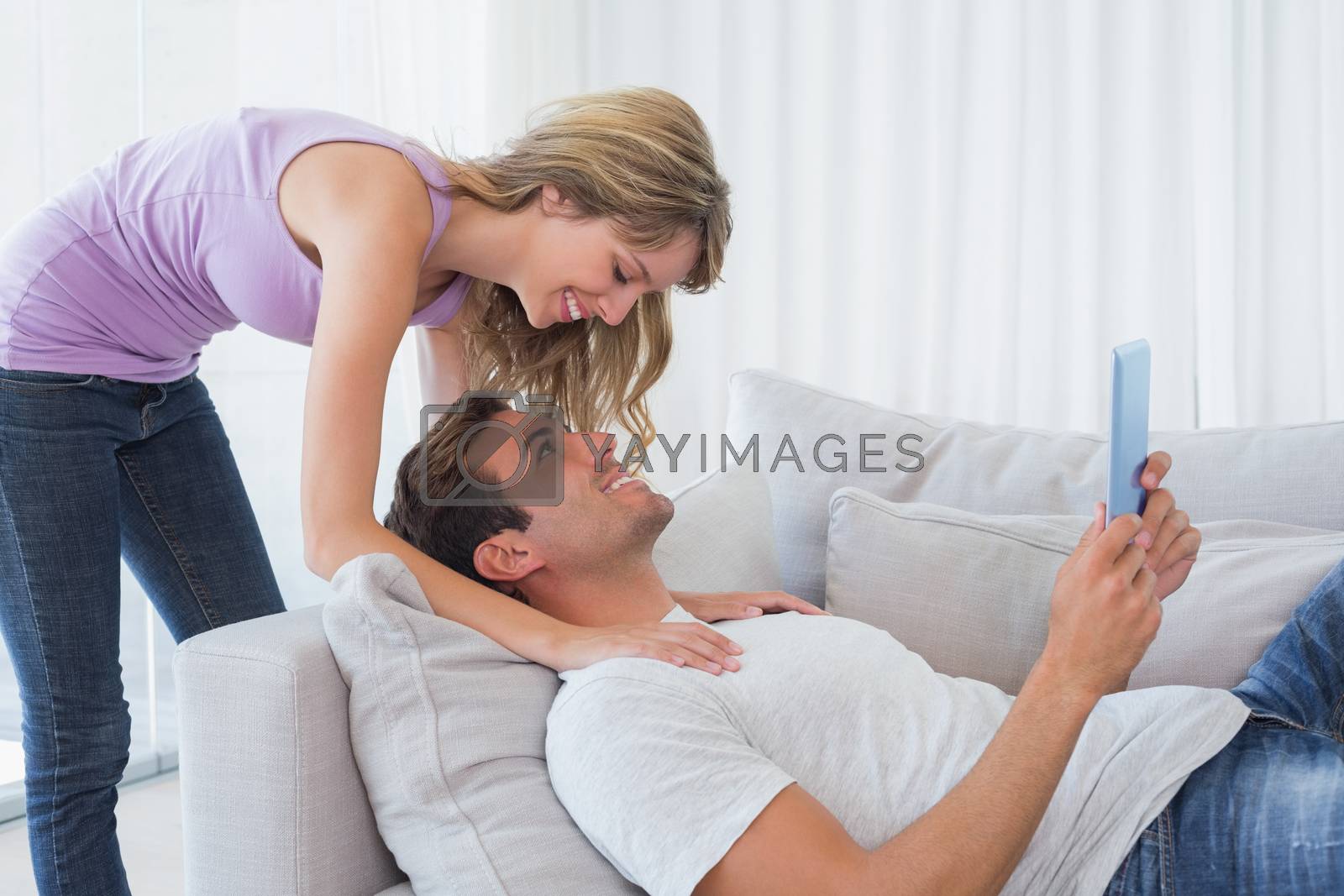 Royalty free image of Woman with man using digital tablet by Wavebreakmedia