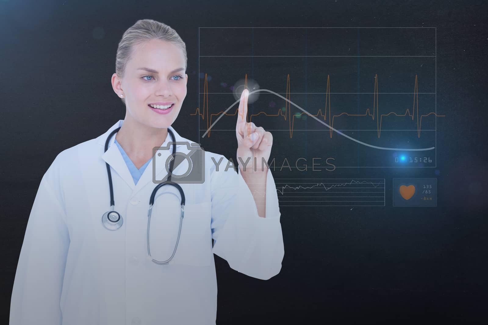 Royalty free image of Woman pointing on heart rate hologram by Wavebreakmedia