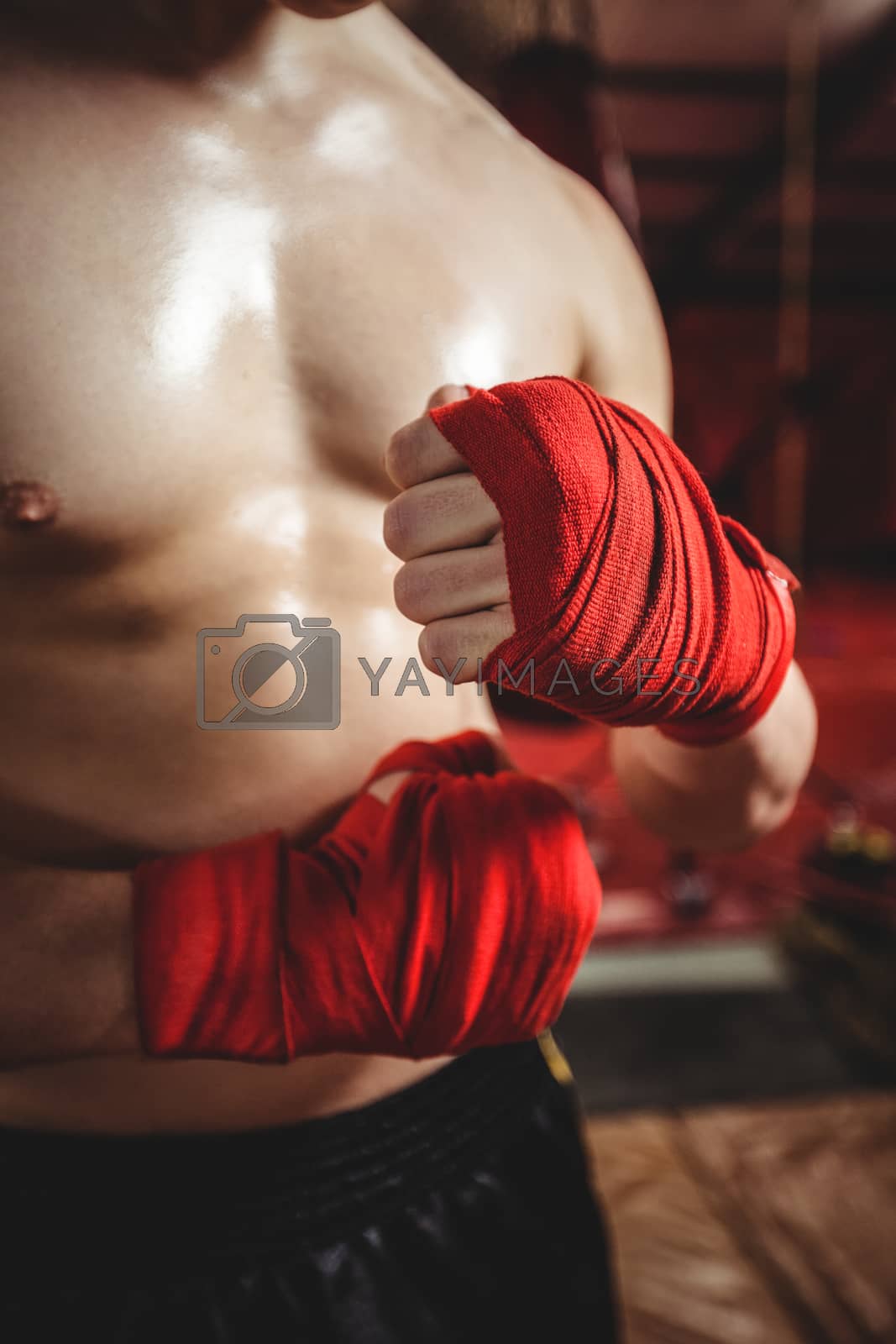 Royalty free image of Boxer wrapping boxing strap by Wavebreakmedia