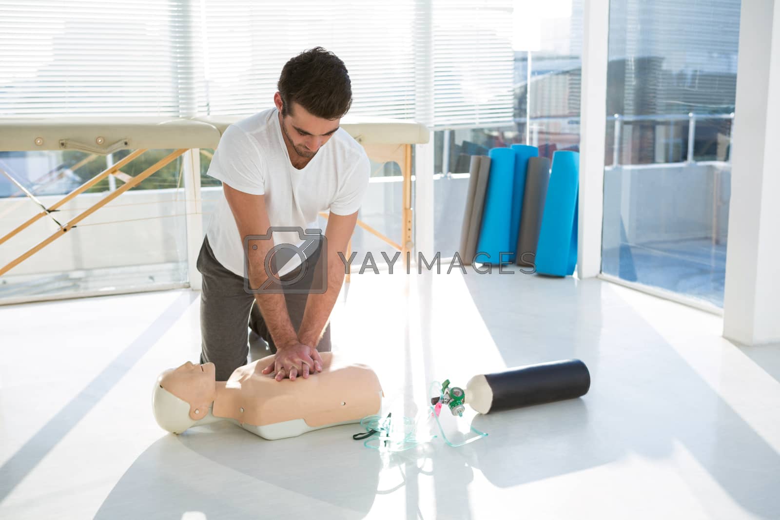 Royalty free image of Paramedic practicing resuscitation on dummy by Wavebreakmedia