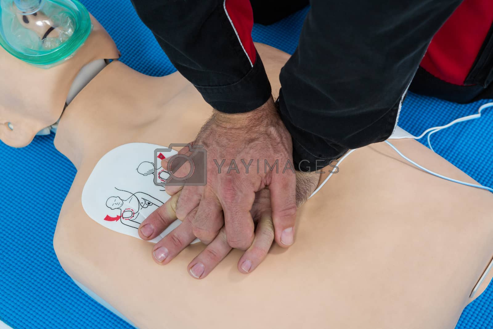 Royalty free image of Paramedic practicing resuscitation on dummy by Wavebreakmedia