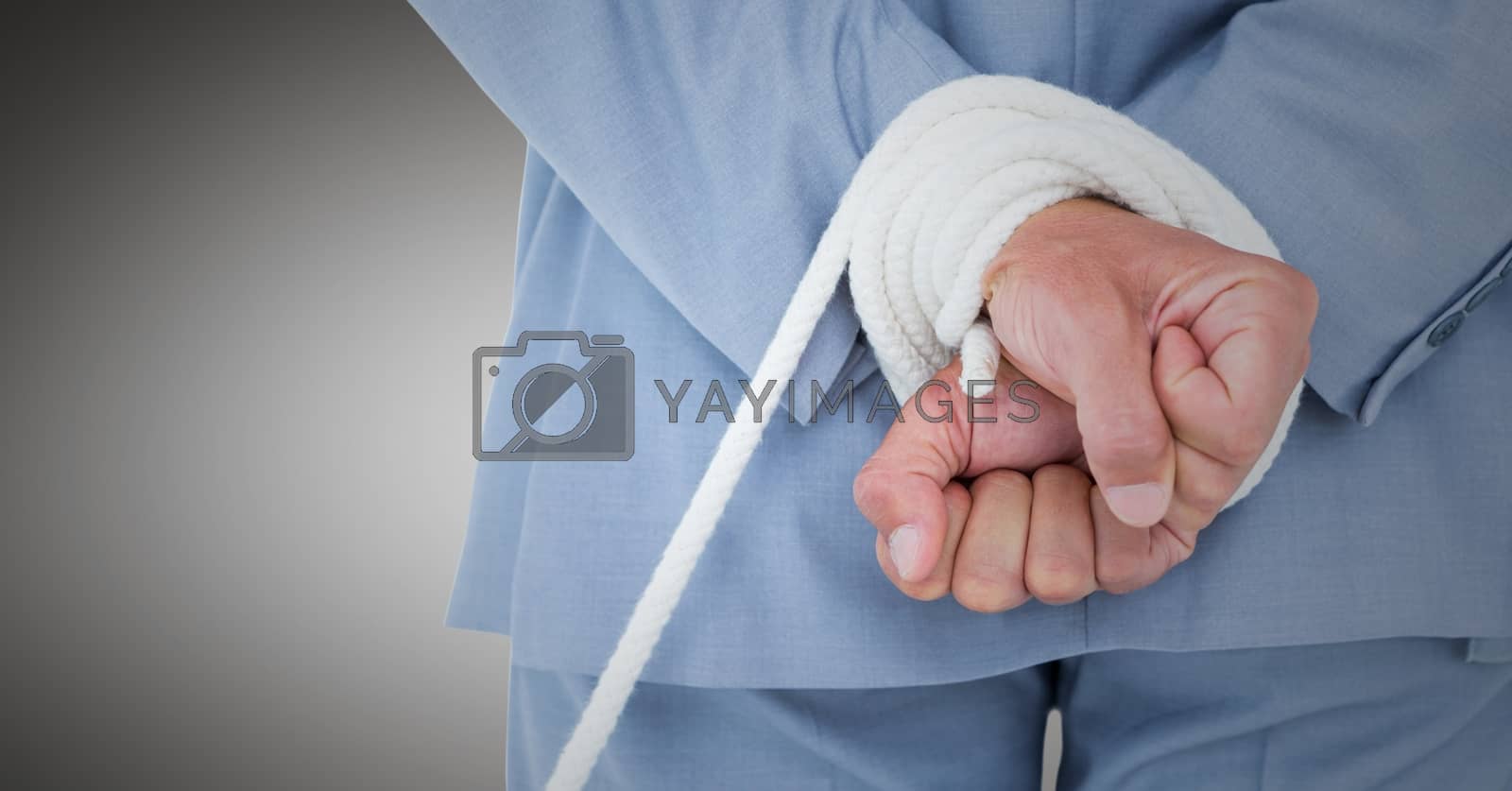Royalty free image of Businessman hands tied up in rope by Wavebreakmedia