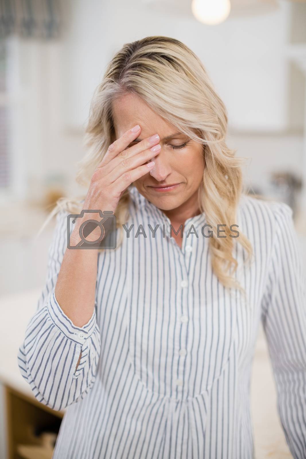 Royalty free image of Tense woman with hand on forehead by Wavebreakmedia