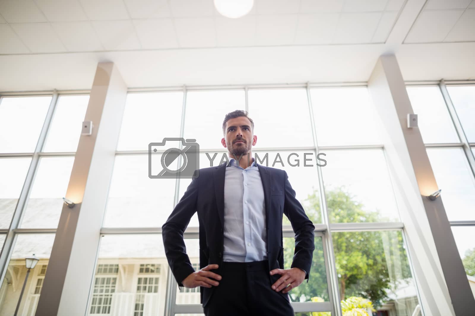 Royalty free image of Businessman standing in conference centre by Wavebreakmedia