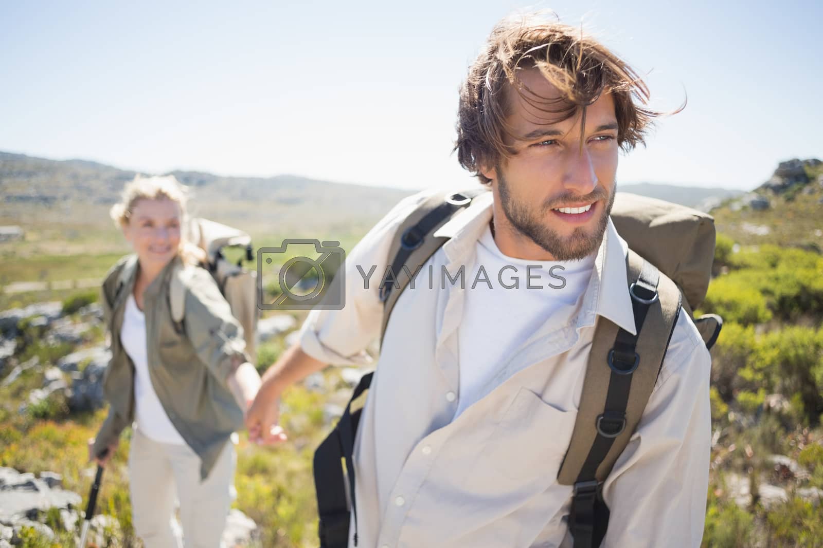 Royalty free image of Hiking couple walking on mountain terrain  by Wavebreakmedia