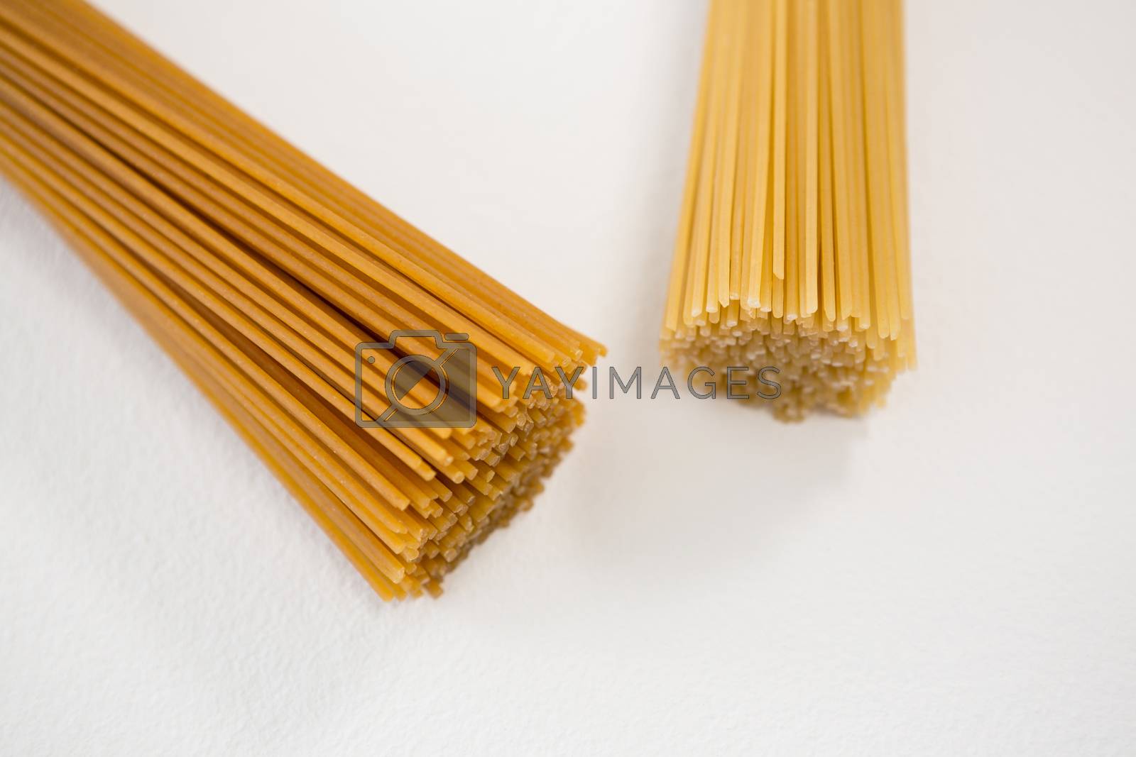 Royalty free image of Bunches of raw spaghetti by Wavebreakmedia
