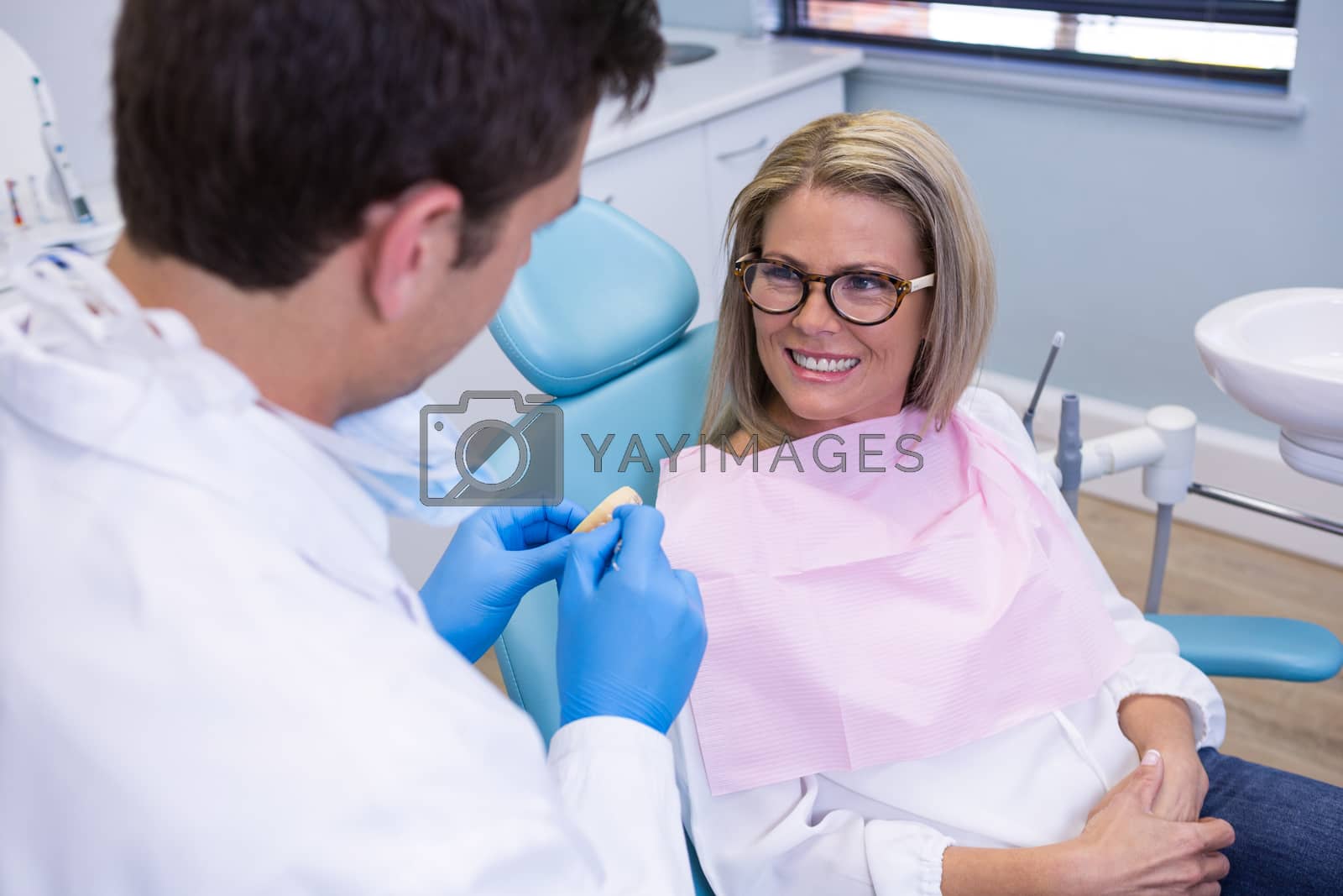Royalty free image of Patient talking with dentist at medical clinic by Wavebreakmedia