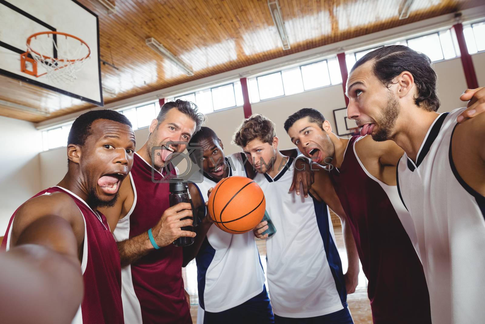 Royalty free image of Happy basketball players making funny faces by Wavebreakmedia