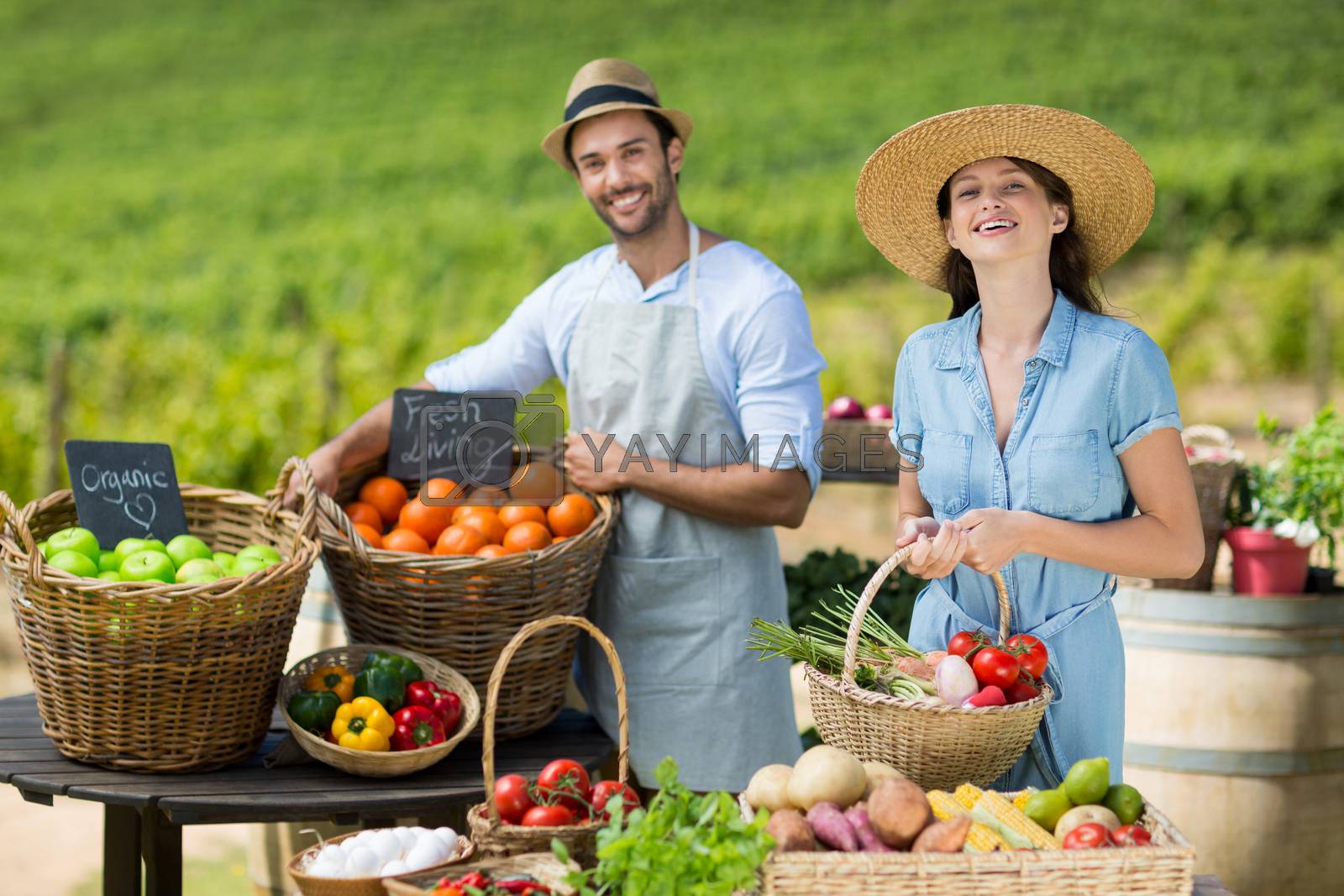 Royalty free image of Smiling friends selling fruits and vegetables by Wavebreakmedia