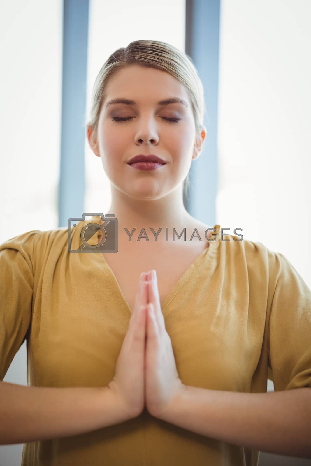 Royalty free image of Executive meditating in office by Wavebreakmedia