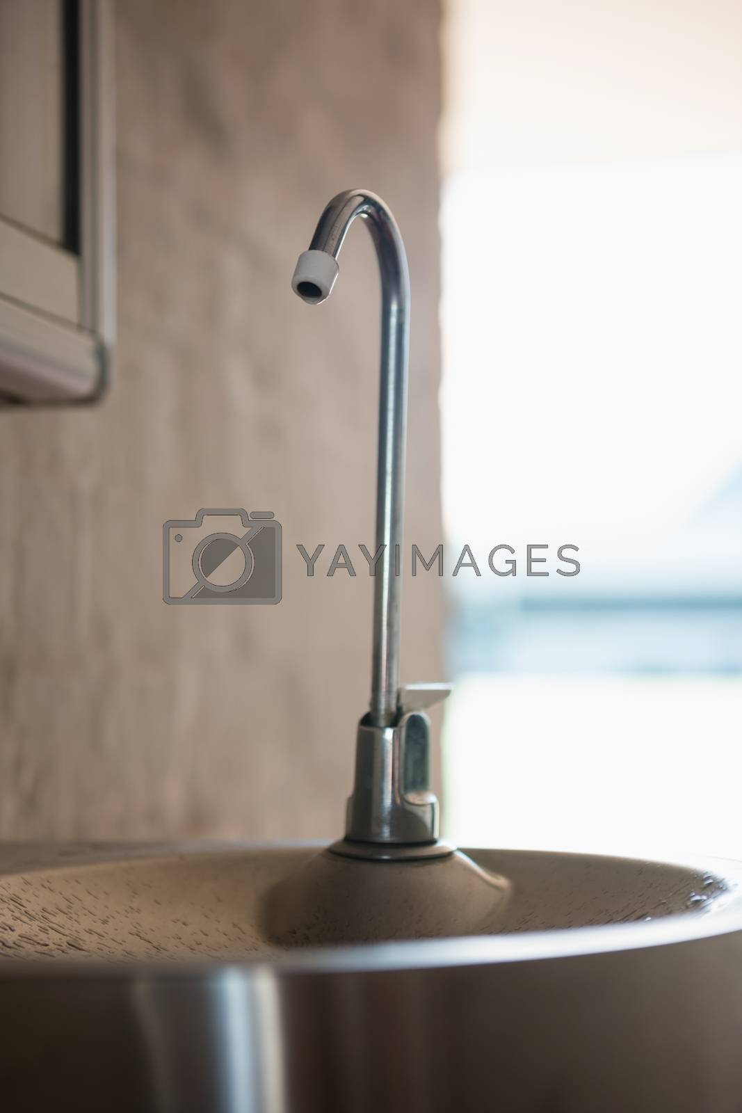 Royalty free image of Close up of faucet on sink by Wavebreakmedia