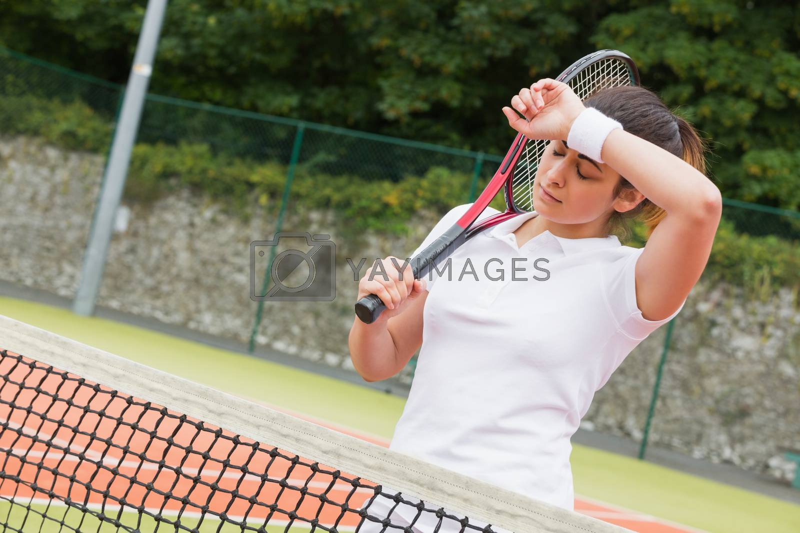 Royalty free image of Pretty tennis player wiping her brow by Wavebreakmedia